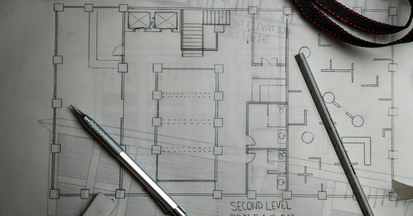Hand-drawn floor plan on tracing paper with a mechanical pencil, eraser and scale ruler, representing the planning that goes into a clear website brief
